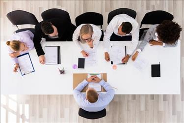 group of employees interviewing a job candidate