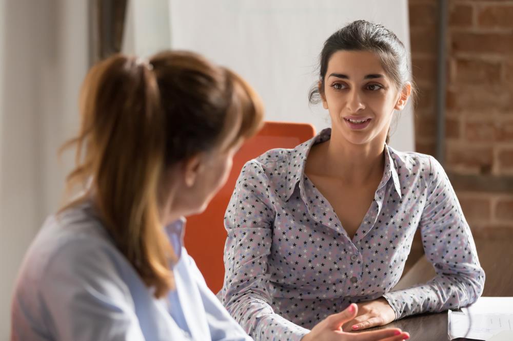 Woman asking question during informational interview