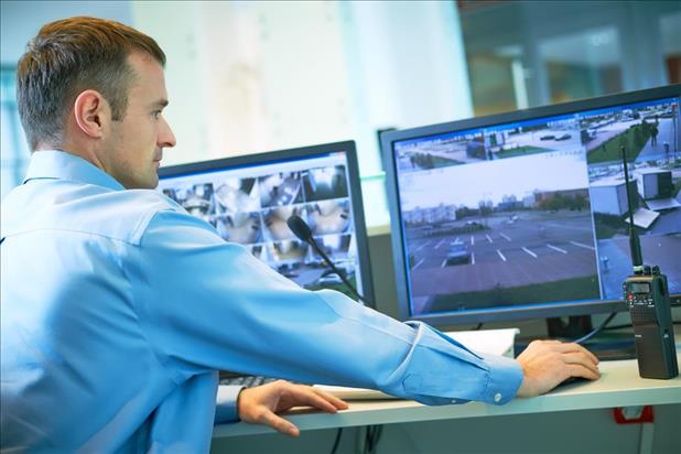 surveillance officer watching monitors