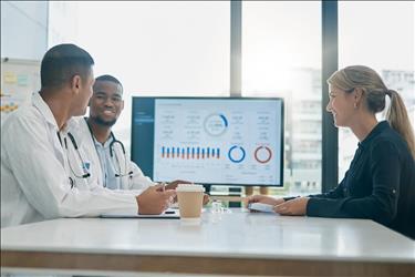 healthcare leadership team looking at data together