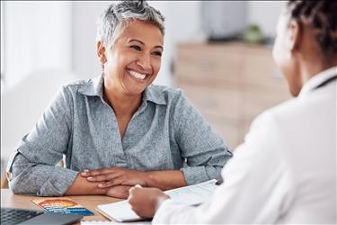 smiling woman meeting with a medical professional