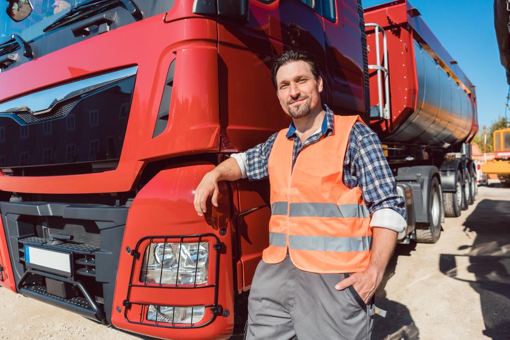 truck driver standing in front of his truck