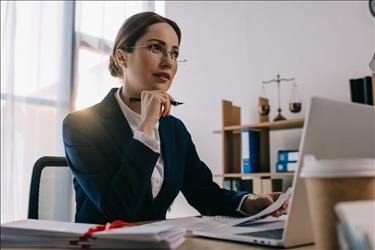 hiring manager reviewing legal resumes at her desk