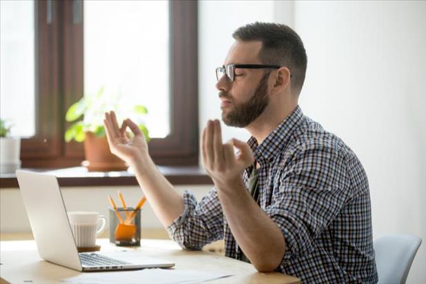 employee meditating while working from home