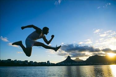 athlete jumping in front of the sunset skyline in Rio de Janeiro, Brazil