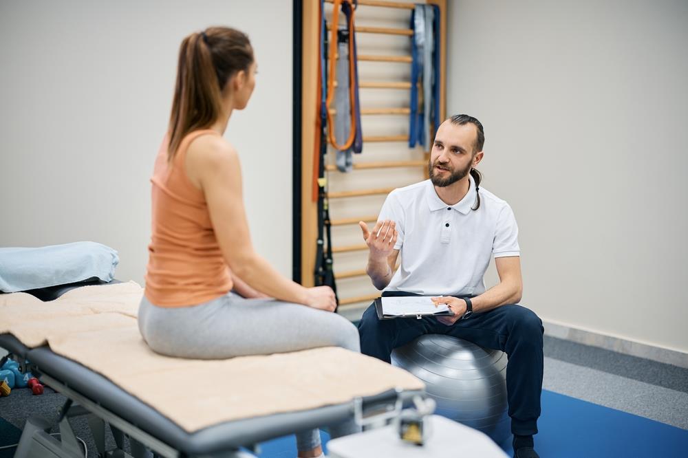 physical therapist talking to patient