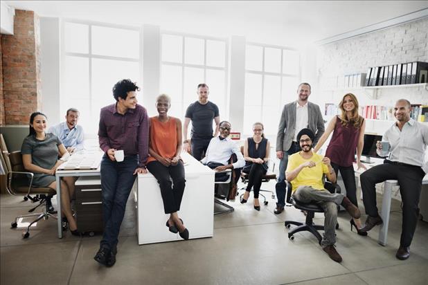 Collaborative team smiling for a group photo