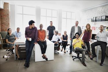 Collaborative team smiling for a group photo