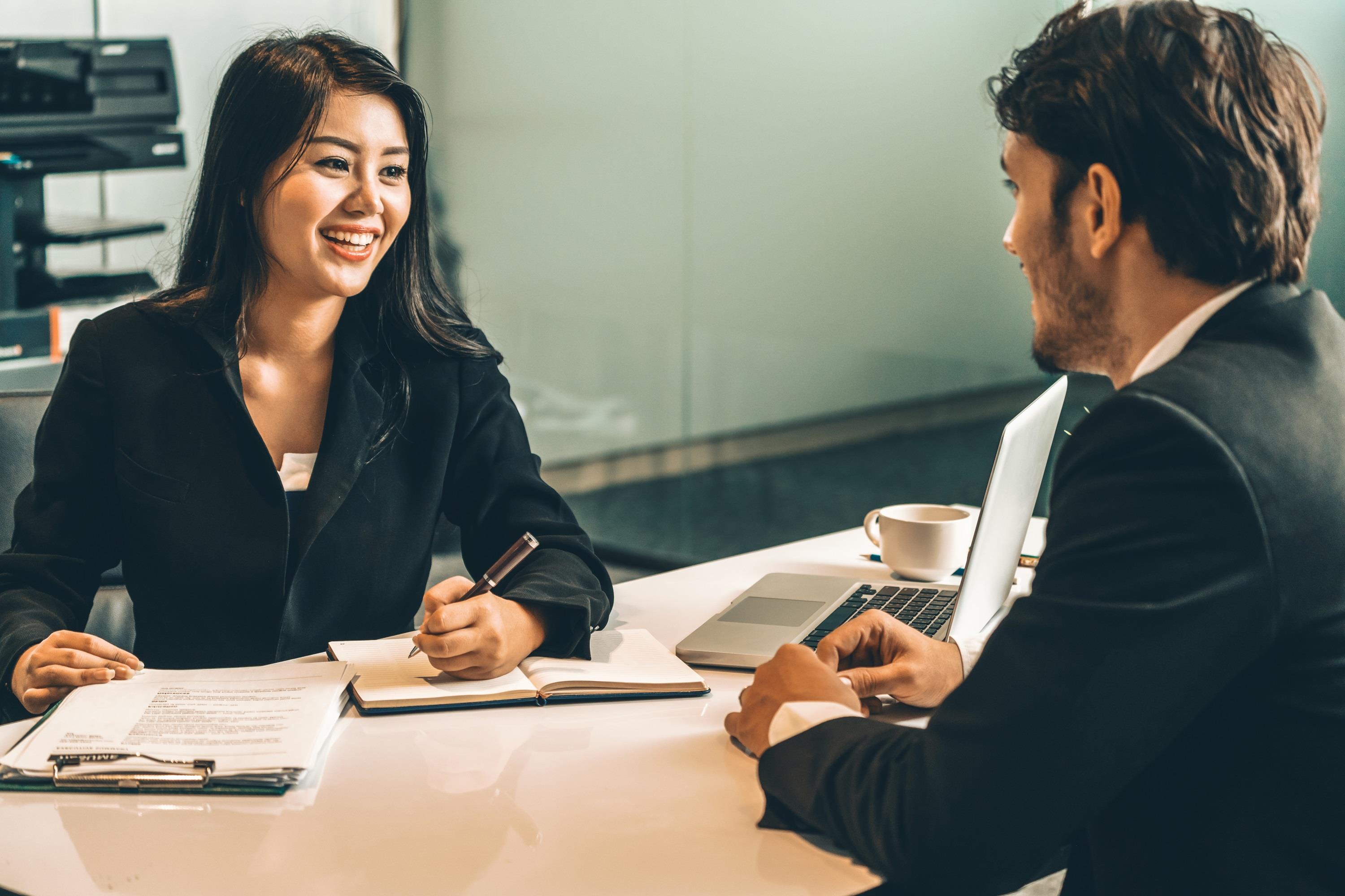 hiring manager smiling while interviewing a candidate