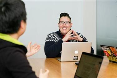 hiring team member smiling while collaborating with other employees