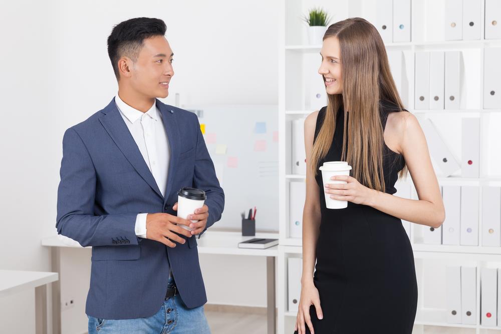 candidate at a company event talking to a current employee