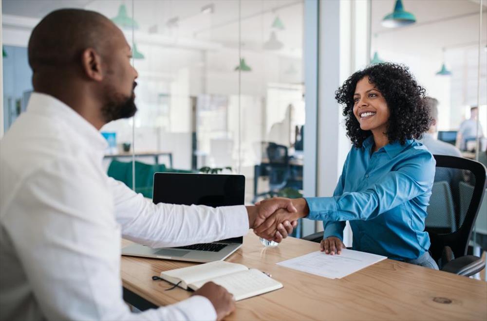 Employee and boss shaking hands