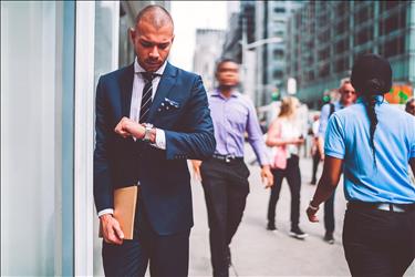 Remote worker checks watch on way back to the office