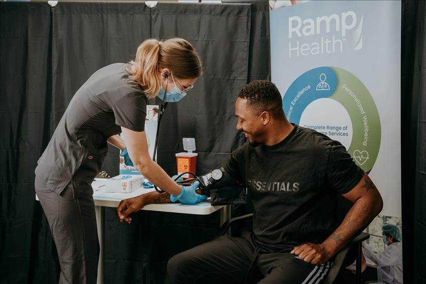 ramp health team member taking a patient's blood pressure