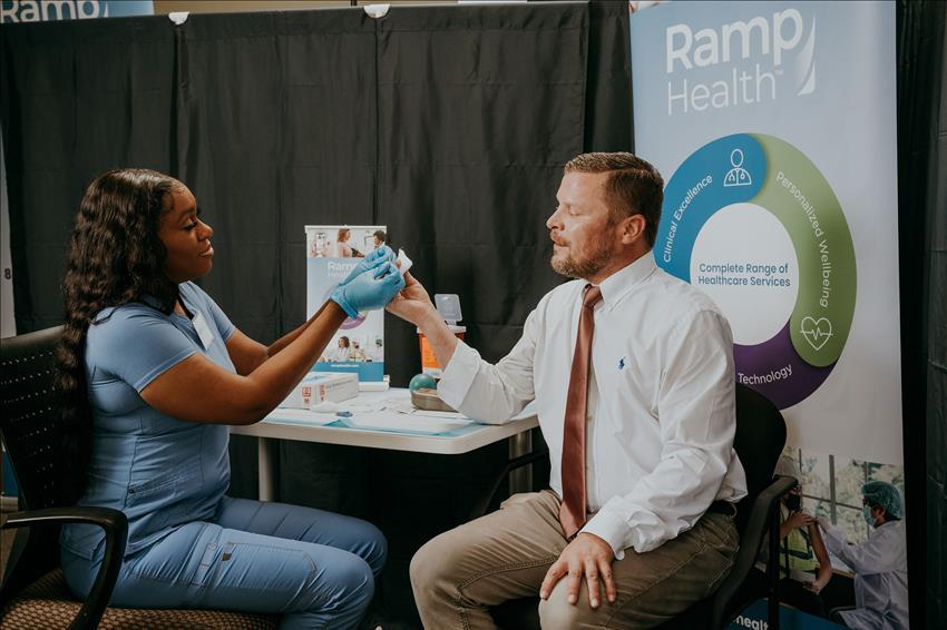 ramp health team member helping a patient