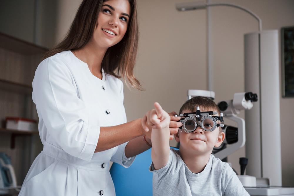 female optometrist with a child patient completing an eye exam