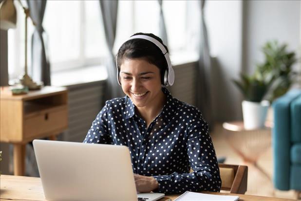 happy remote worker on a video call with her colleagues from home