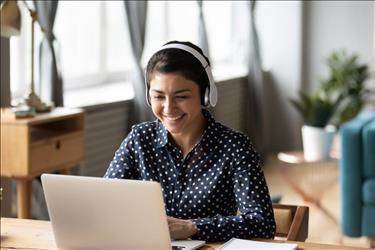 happy remote worker on a video call with her colleagues from home