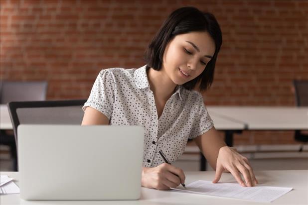 job seeker taking notes while preparing for an interview