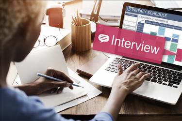 Woman putting interview on calendar and taking notes