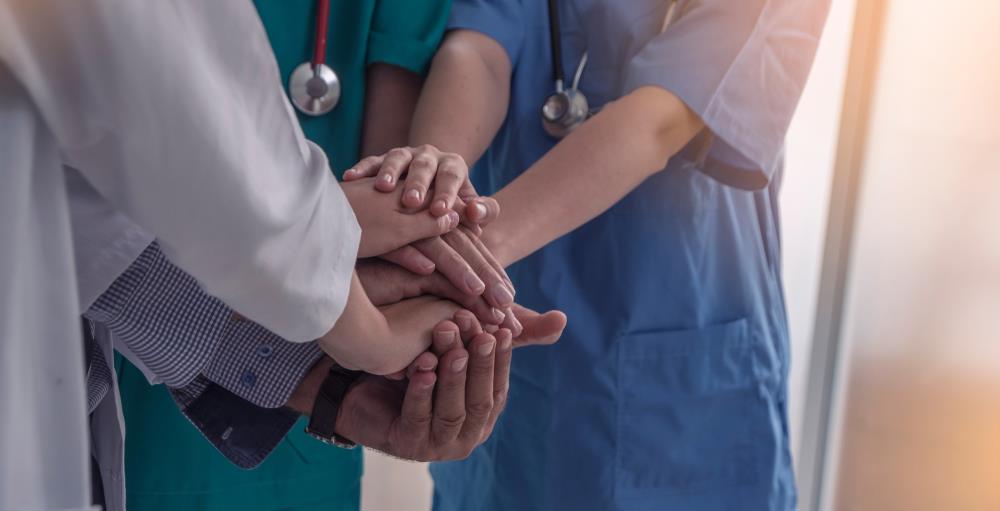 volunteer medical team putting their hands together