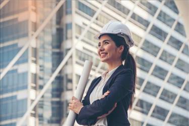 woman with a hardhat and diagrams