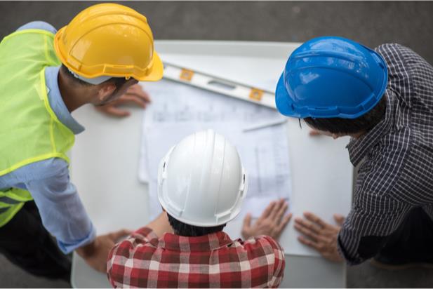 three civil engineers looking at a diagram