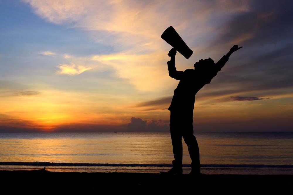 Individual shouting into a megaphone to represent use of emphasis on a resume