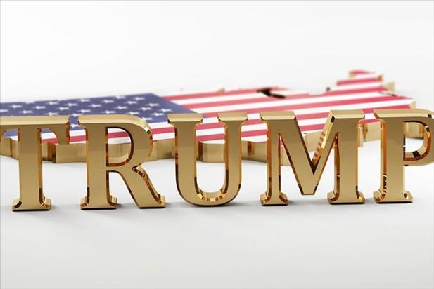 Trump's name in gold in front of United States model