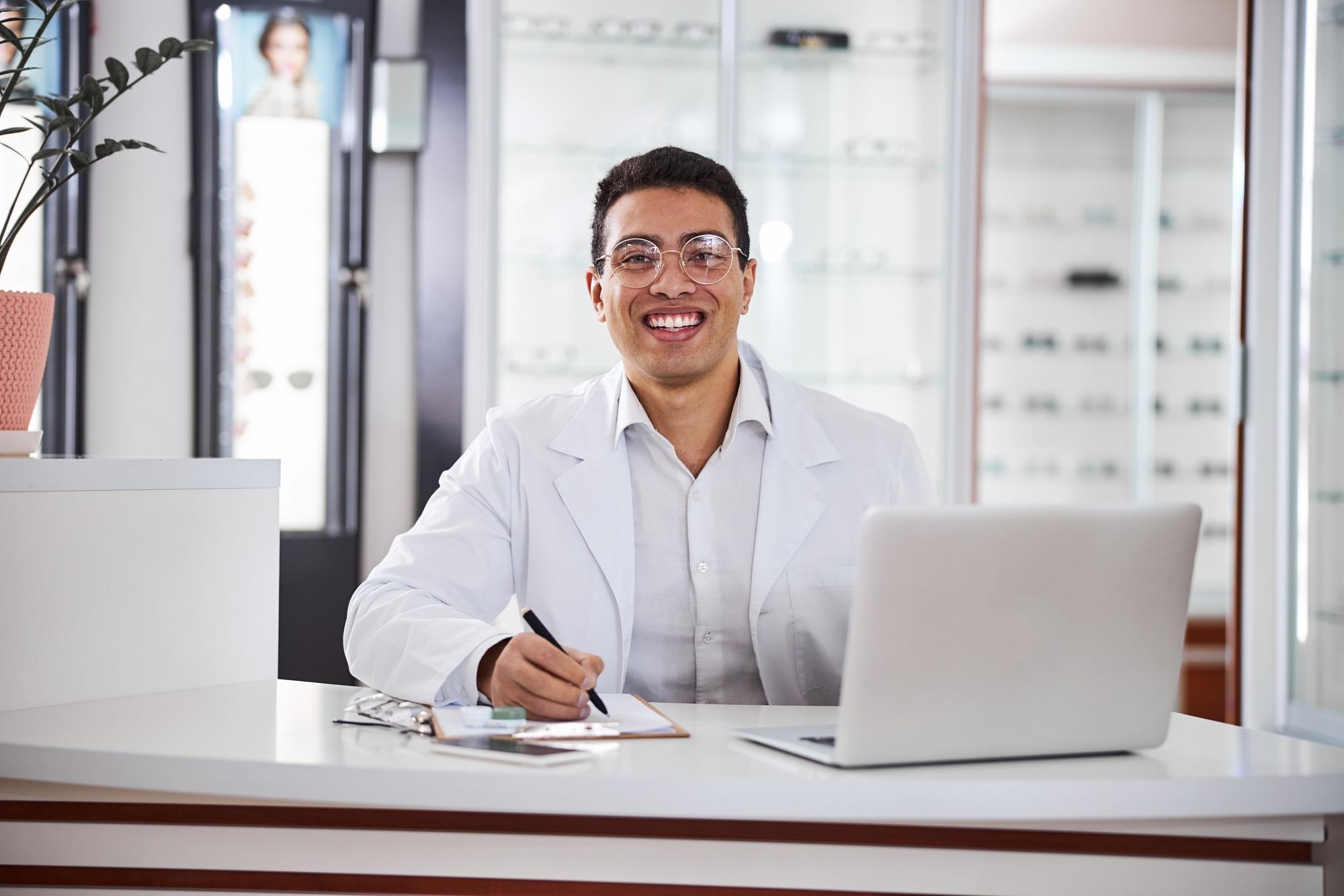 smiling optometrist in his practice