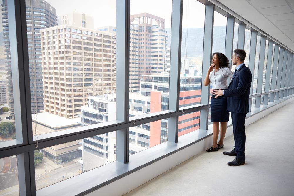 Commercial real estate agent showing client around an empty office building