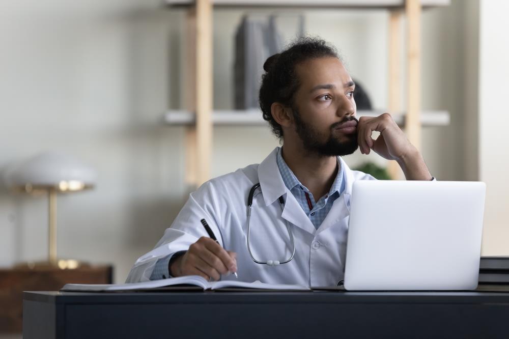 concerned doctor sitting at their desk