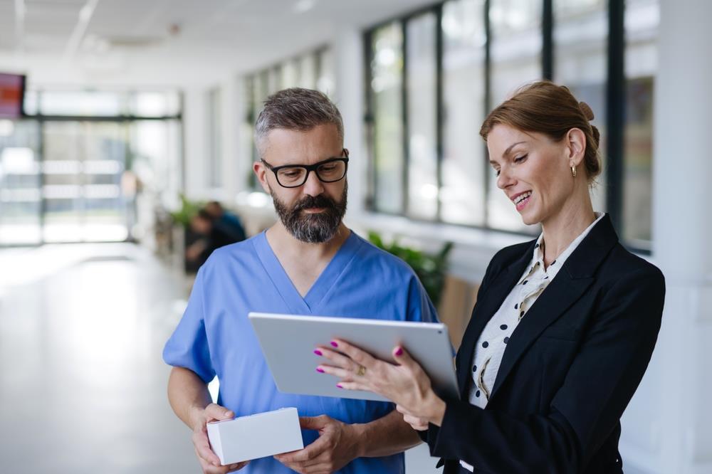 healthcare workers looking at a chart on a tablet