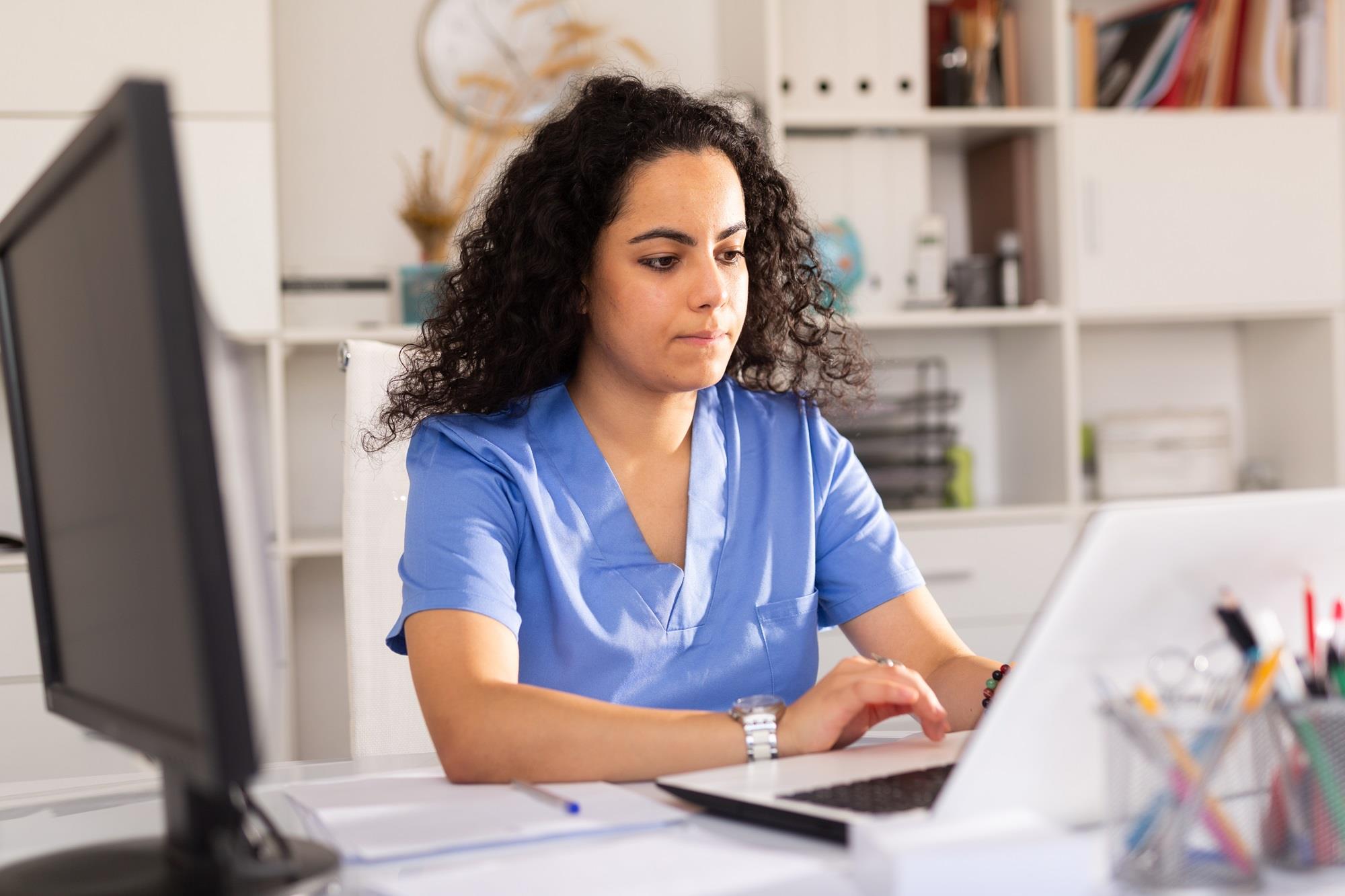 medical professional working on her laptop