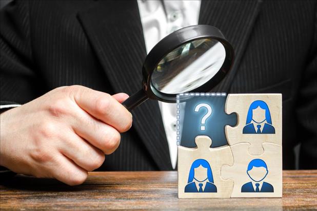 magnifying glass on job candidates