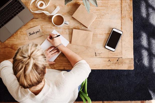 woman writing thank you note