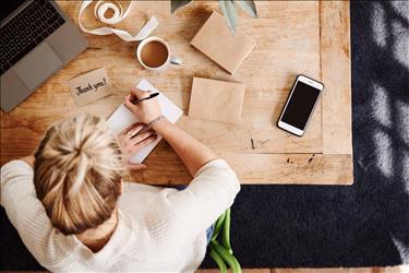 woman writing thank you note