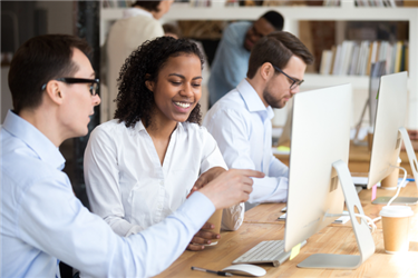 Group of young professionals reading and discussing the top career advice articles of 2018