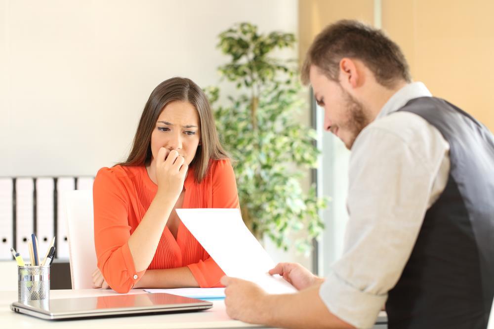 job seeker showing concern while interviewer reviews her resume