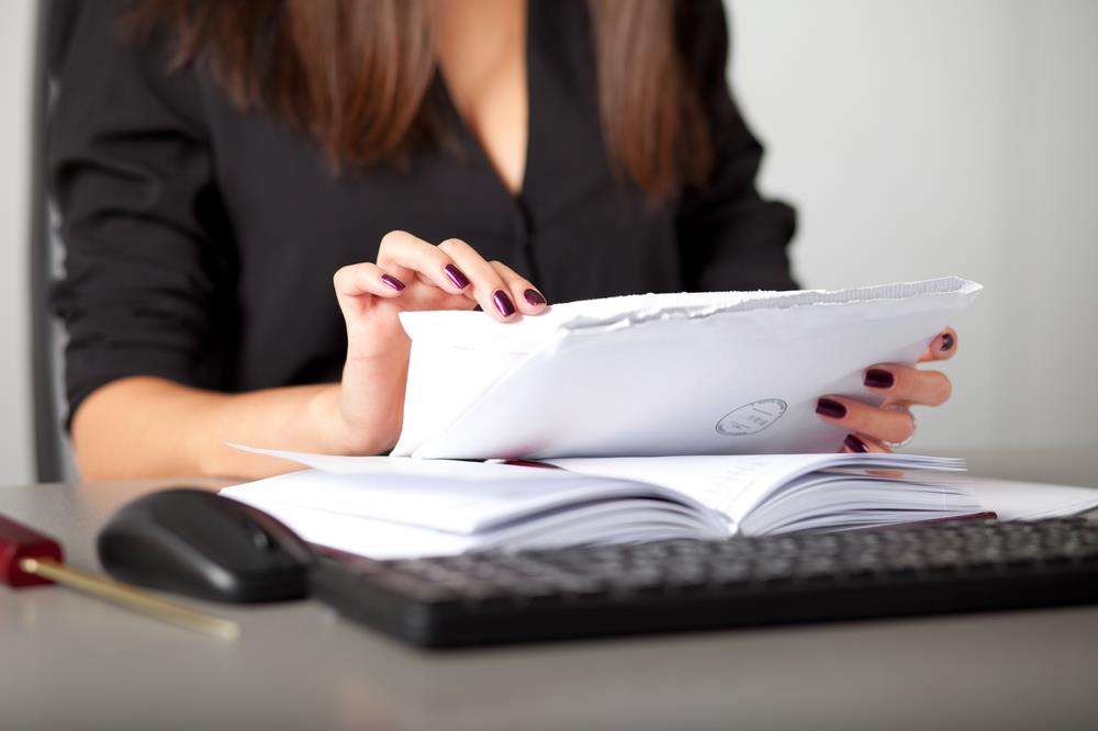 receptionist sorting mail at her desk