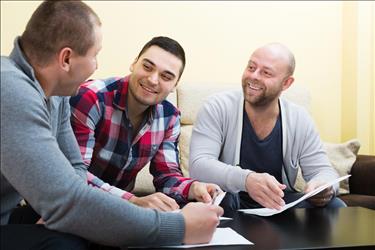 male social worker meeting with two clients