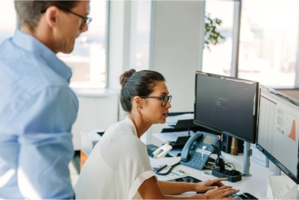 workers looking at monitors on stands