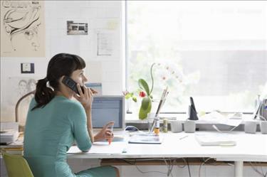 Professional sitting at desk and undergoing a phone interview