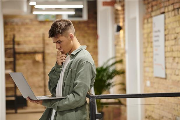 gen z job seeker looking at his laptop