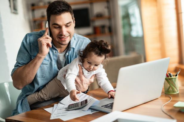 man working from home with his child