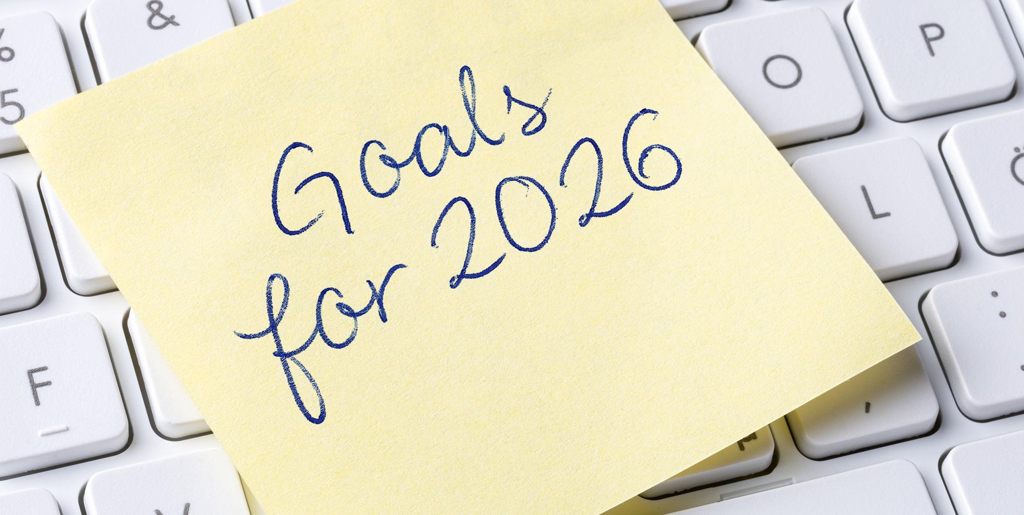 goals for 2026 written on a sticky note on a keyboard