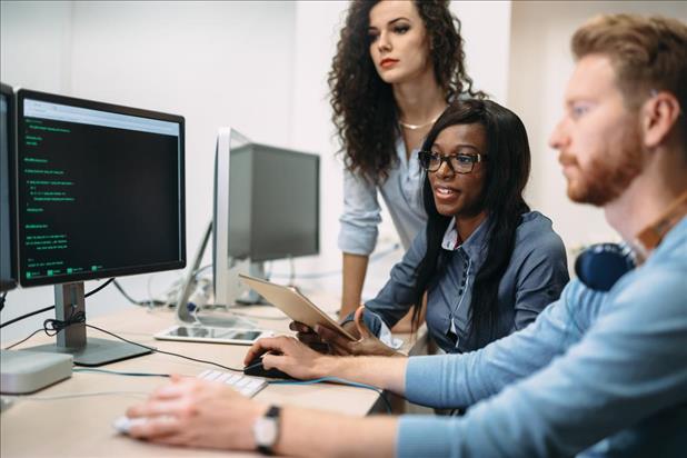 group of IT professionals working on a software program