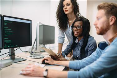 group of IT professionals working on a software program