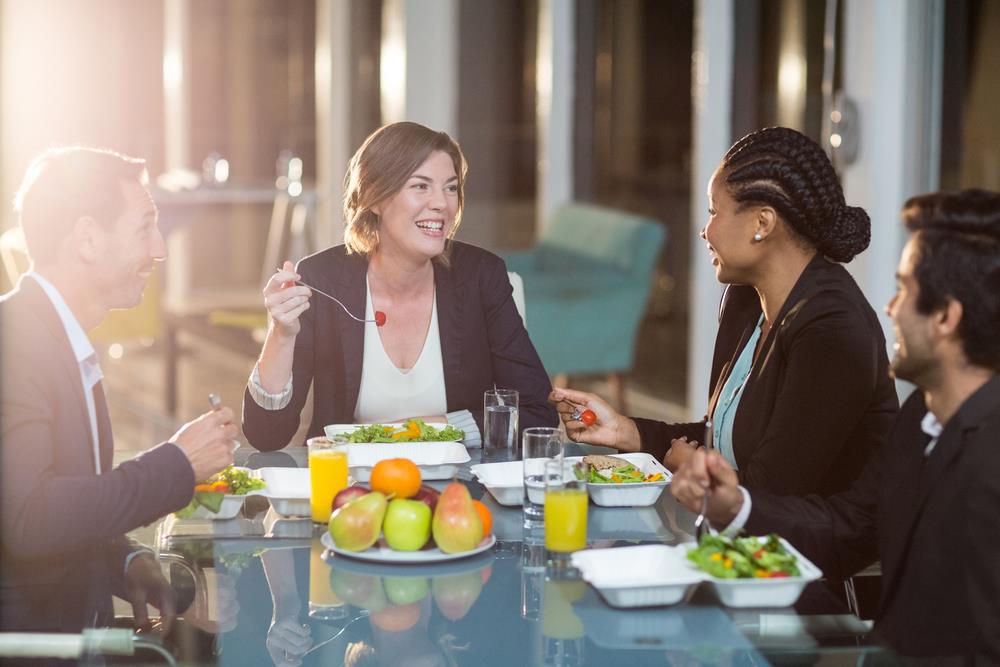 employees having breakfast together at work