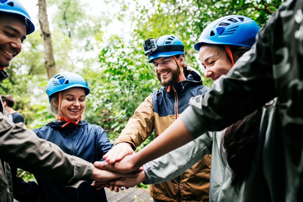 employees zip lining together for a team building event